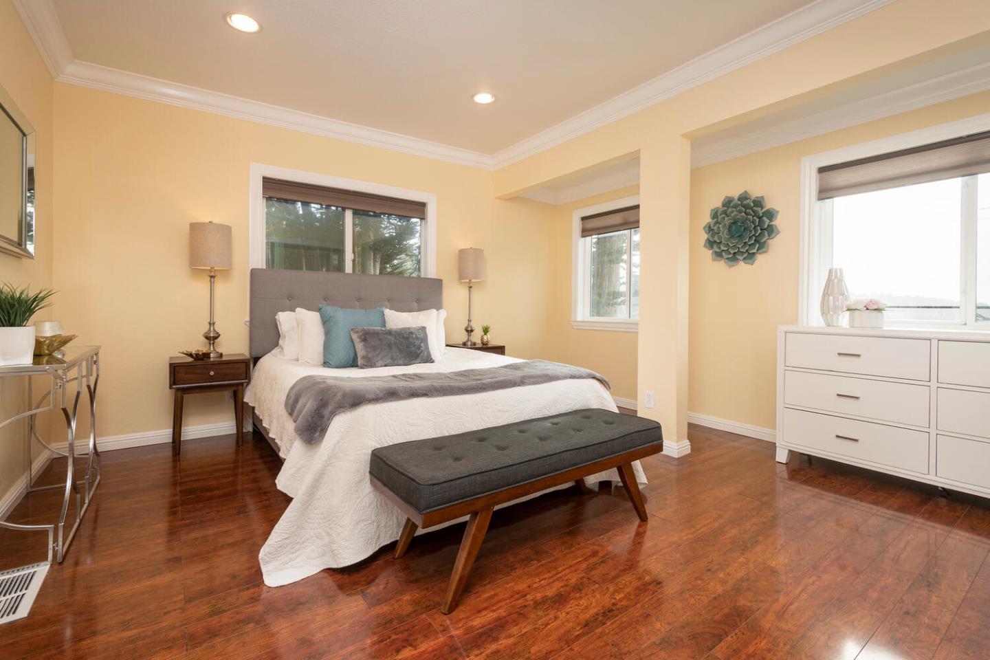 301 Channing Way Pacifica, CA 94044 - Photo 16 of 35 a bedroom with a bed and a dresser