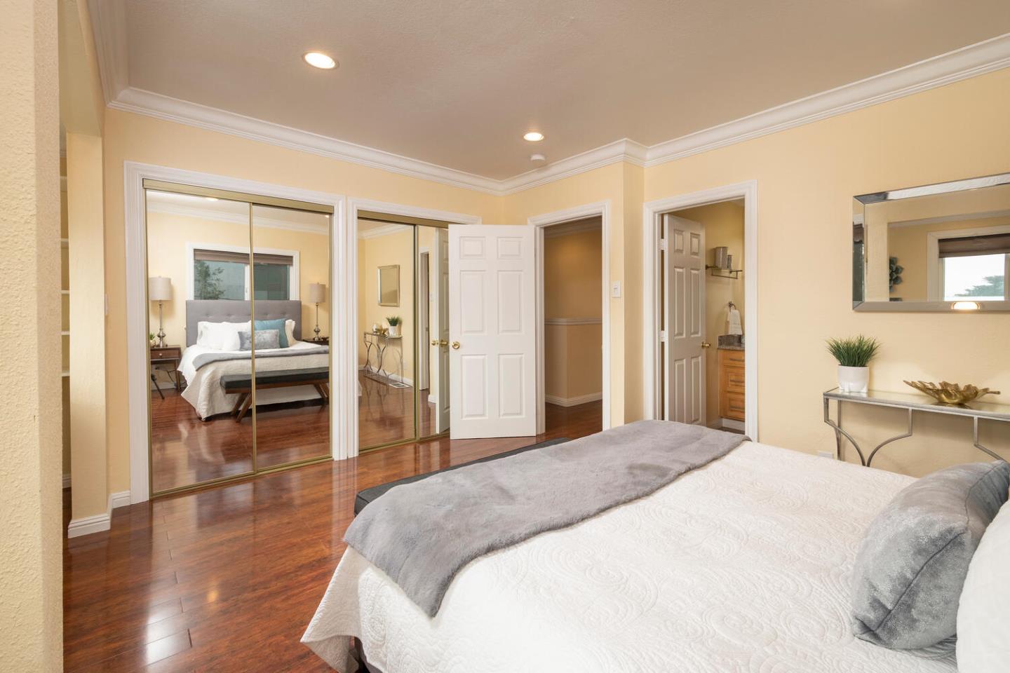 301 Channing Way Pacifica, CA 94044 - Photo 17 of 35 a spacious bedroom with a bed and wooden floor