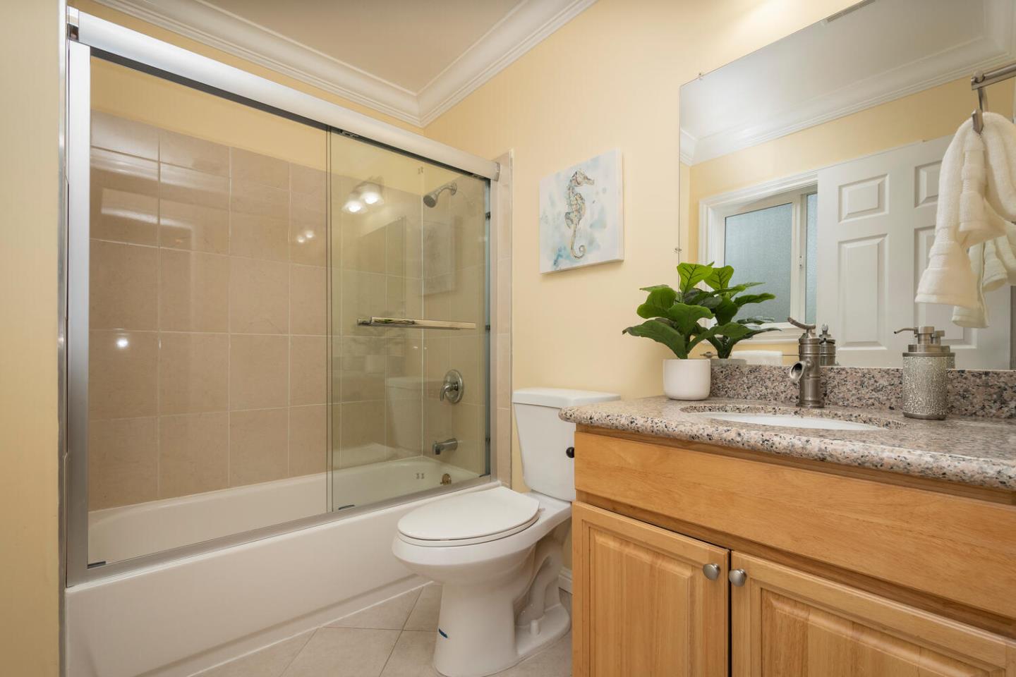 301 Channing Way Pacifica, CA 94044 - Photo 20 of 35 a bathroom with a granite countertop sink a toilet and shower