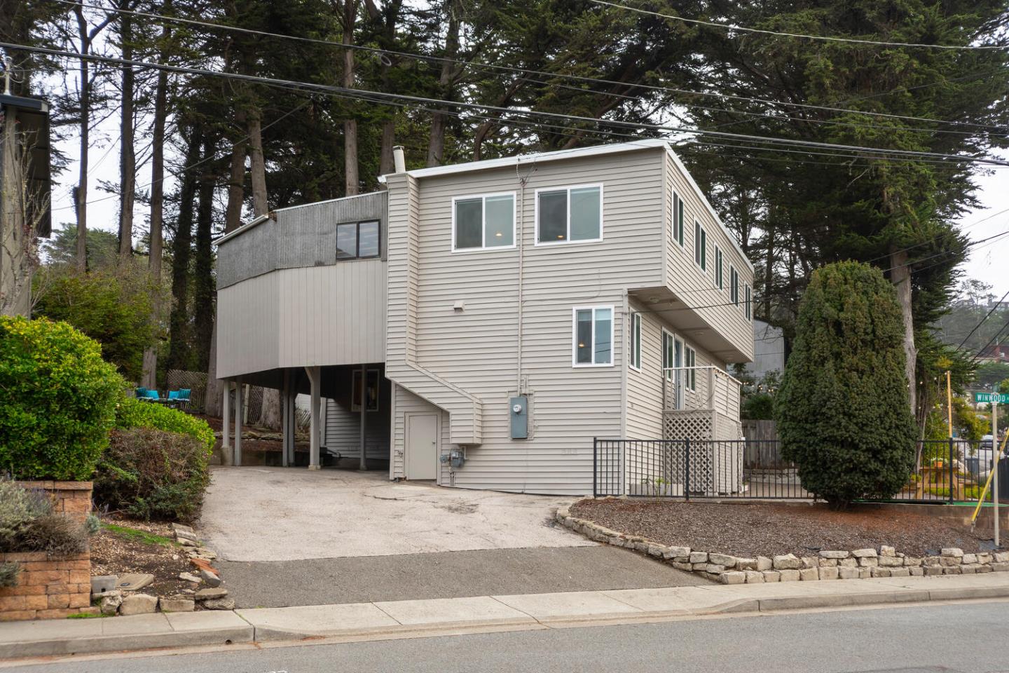 301 Channing Way Pacifica, CA 94044 - Photo 26 of 35 a front view of a house with a yard and garage