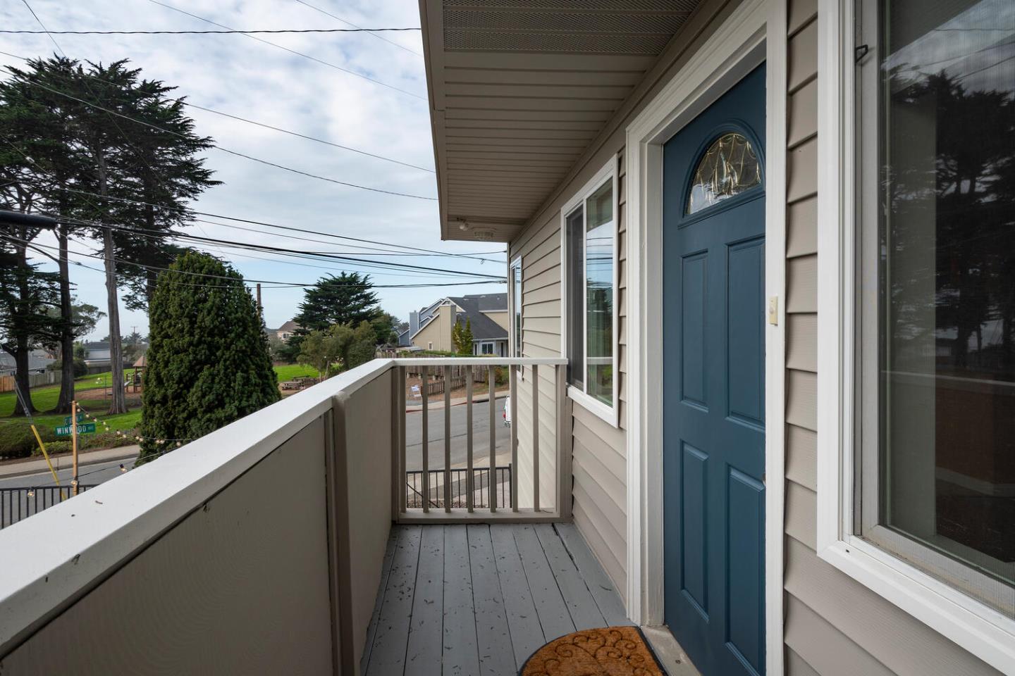 301 Channing Way Pacifica, CA 94044 - Photo 3 of 35 a view of a balcony with wooden floor and floor to ceiling window