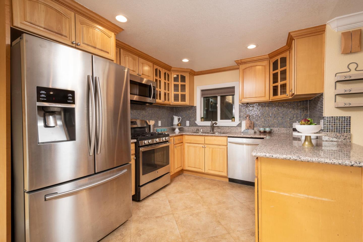 301 Channing Way Pacifica, CA 94044 - Photo 8 of 35 a kitchen with stainless steel appliances granite countertop a refrigerator a stove a sink and a microwave