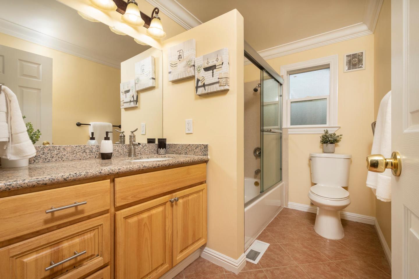 301 Channing Way Pacifica, CA 94044 - Photo 10 of 35 a bathroom with a granite countertop sink a toilet and a mirror