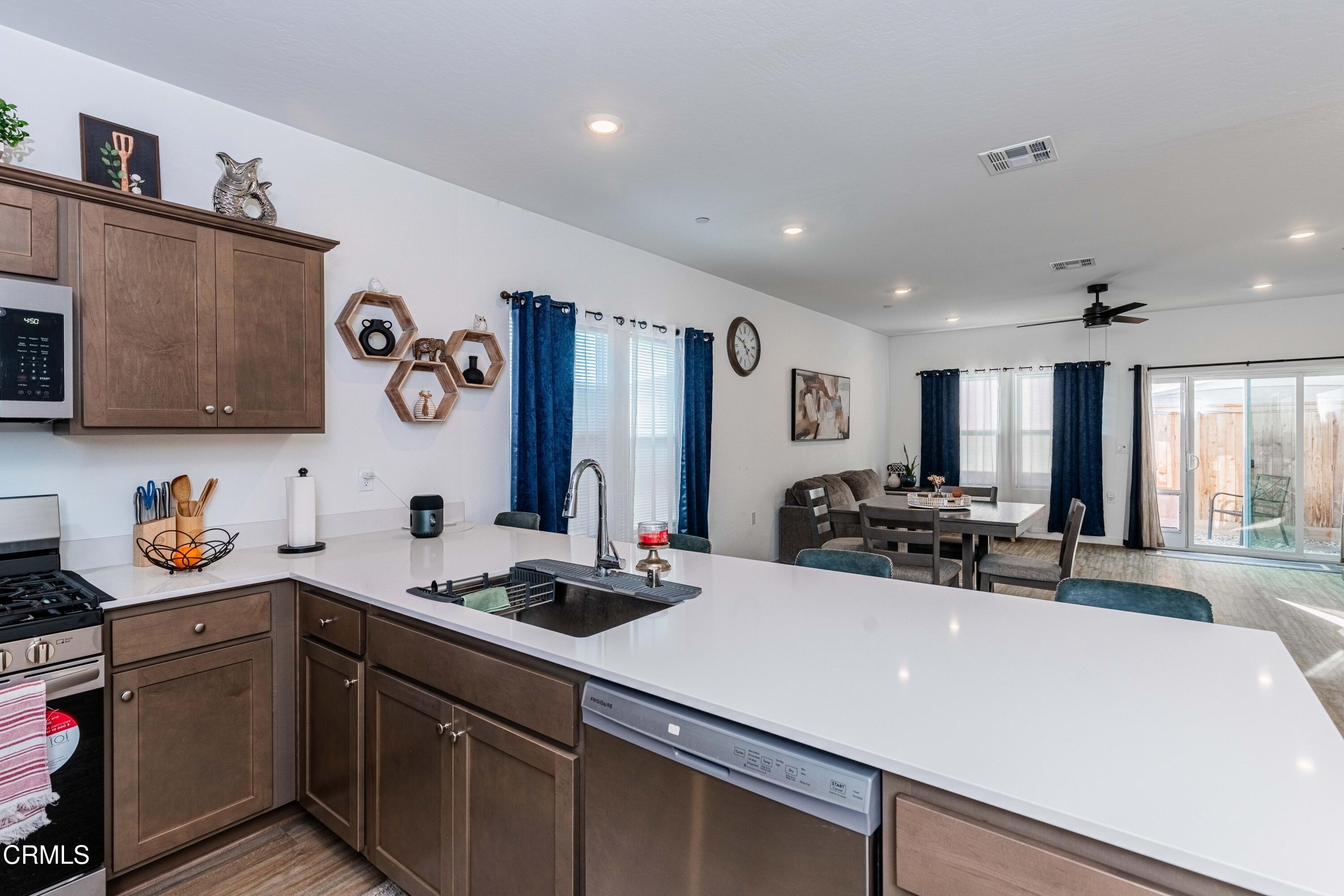 3305 Lilac View Shafter, CA 93263 - Photo 12 of 36 a kitchen with a sink a stove and cabinets
