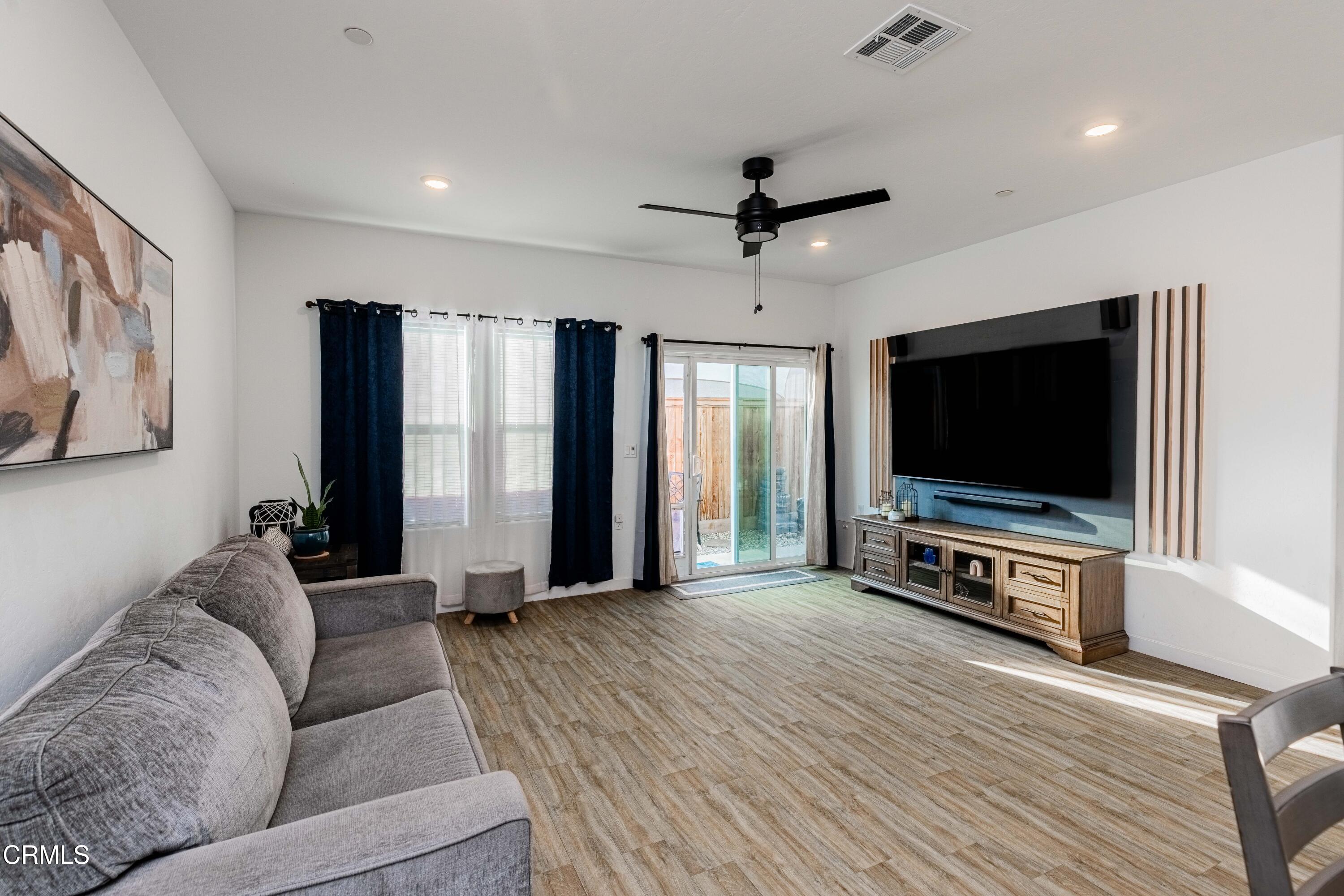 3305 Lilac View Shafter, CA 93263 - Photo 18 of 36 a living room with furniture and a flat screen tv