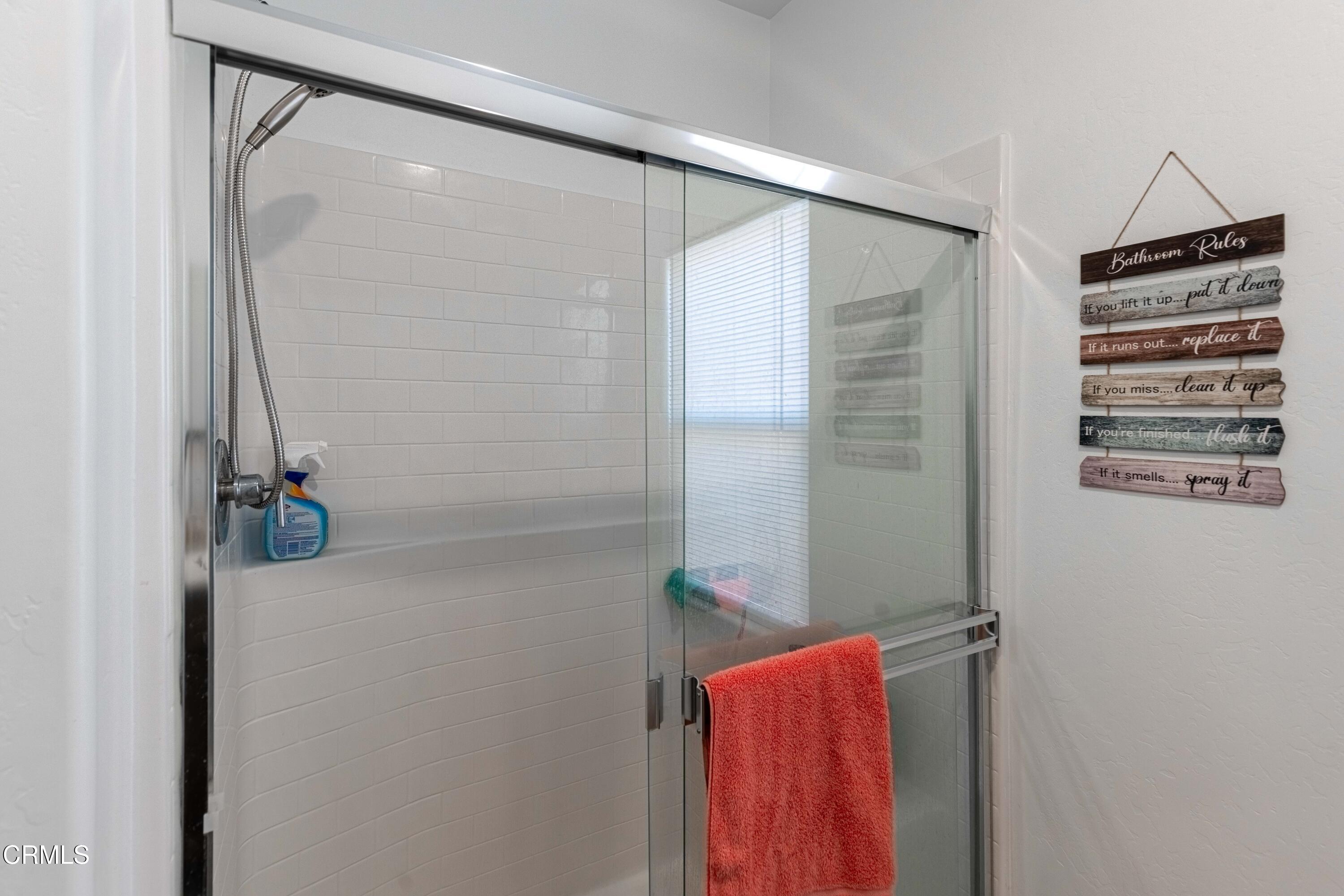 3305 Lilac View Shafter, CA 93263 - Photo 26 of 36 a bathroom with a shower and a mirror