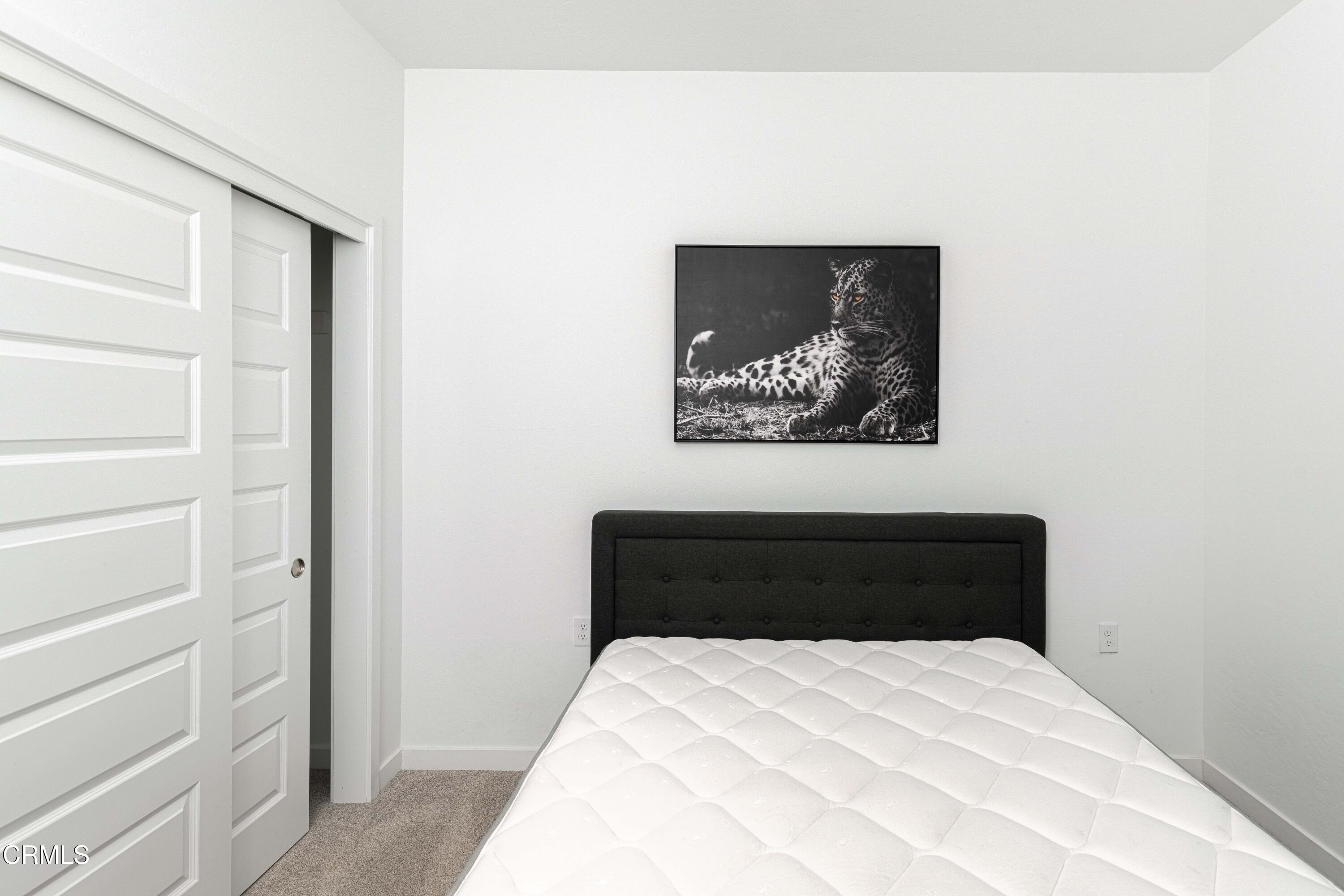 3305 Lilac View Shafter, CA 93263 - Photo 28 of 36 a bedroom with a bed and a painting on the wall