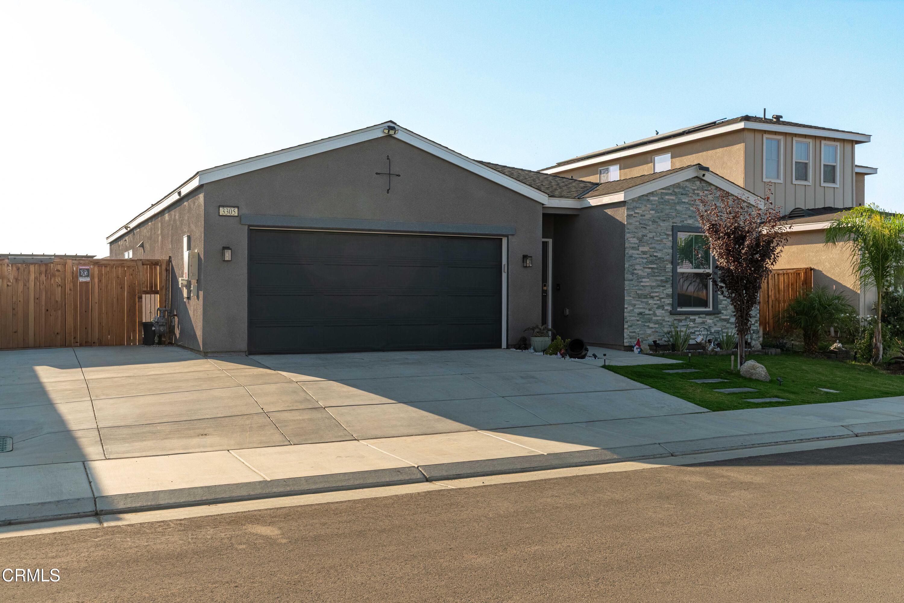 3305 Lilac View Shafter, CA 93263 - Photo 6 of 36 a front view of a house with a yard