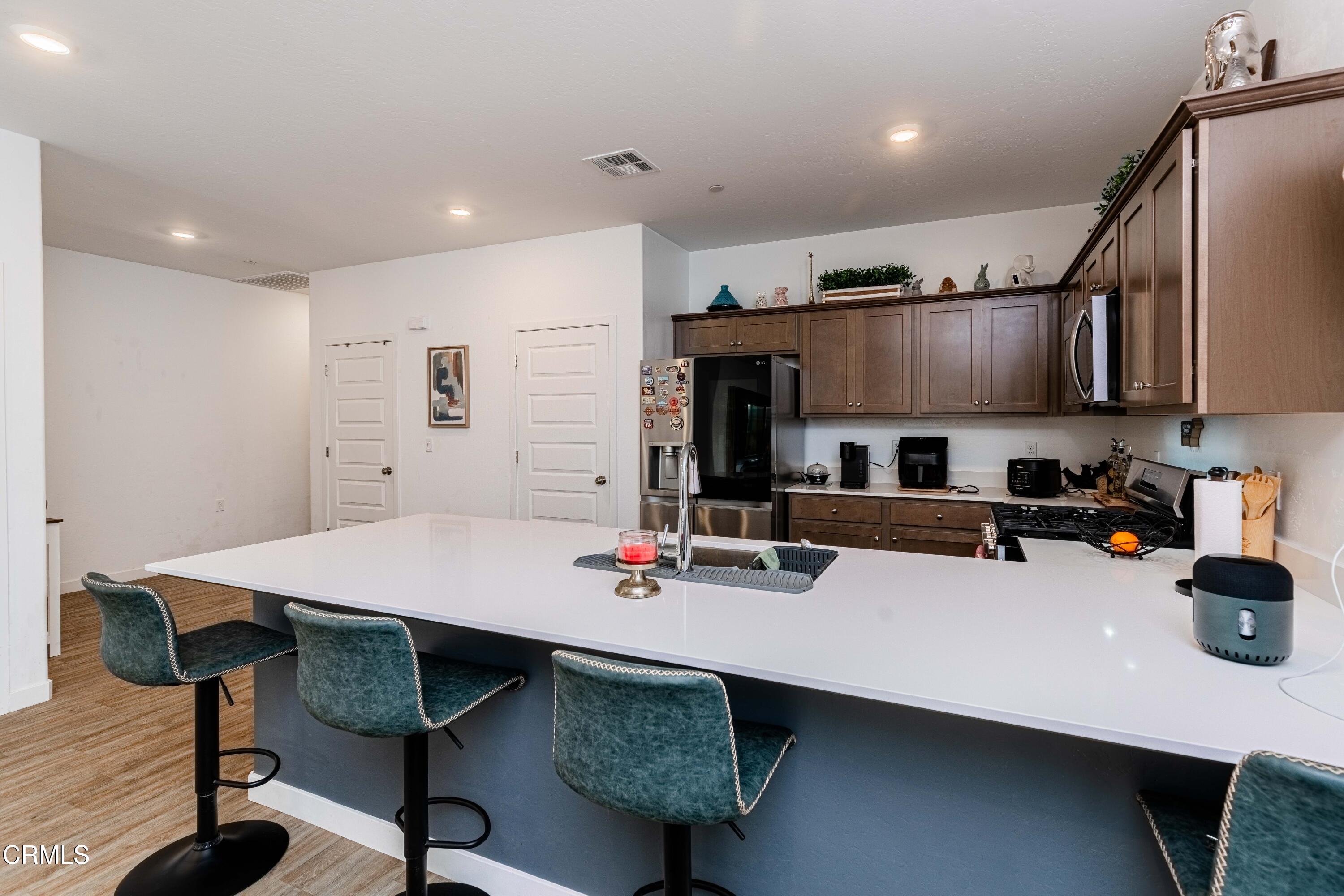 3305 Lilac View Shafter, CA 93263 - Photo 8 of 36 a large kitchen with a table and chairs