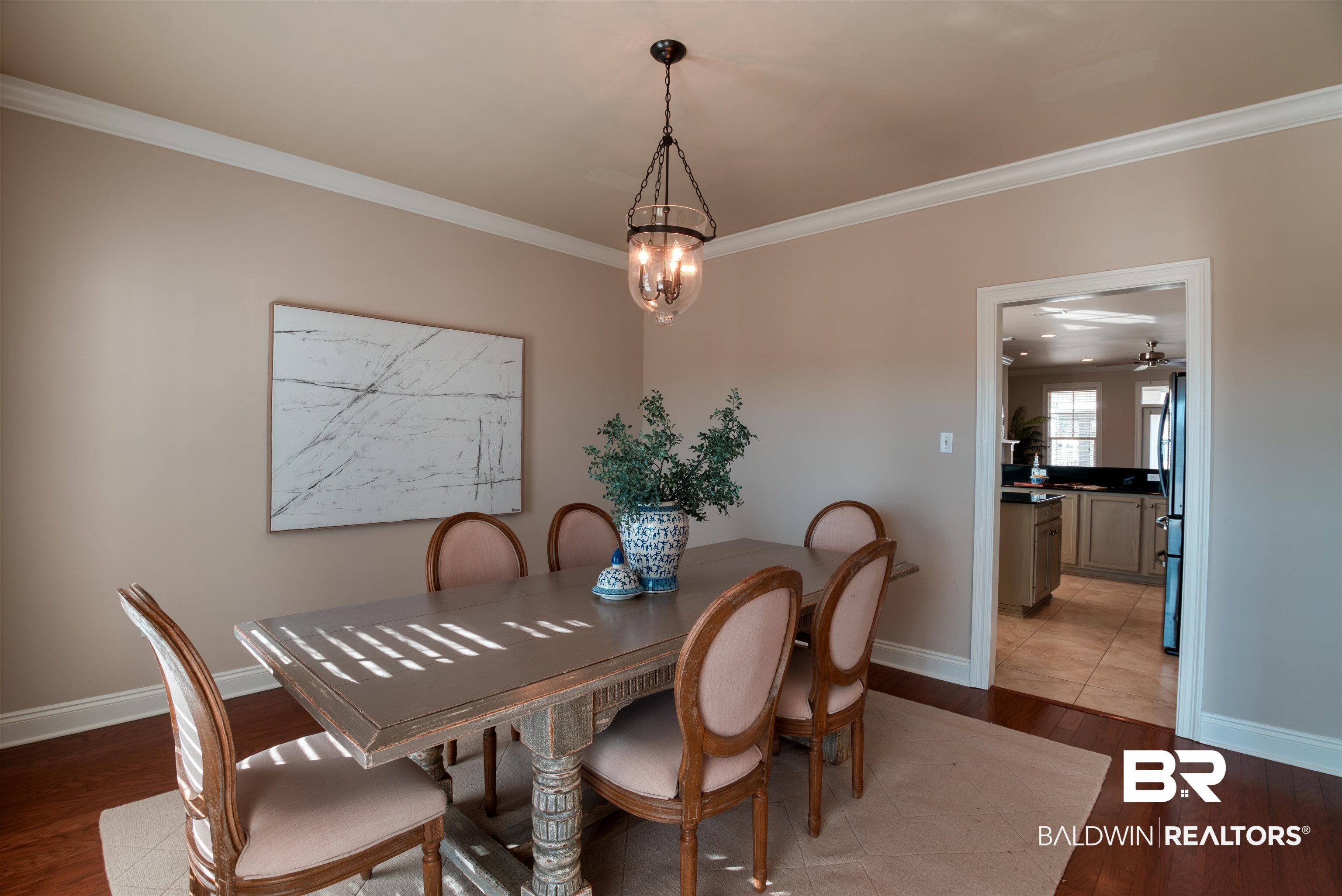 24561 Austin Road Daphne, AL 36526 - Photo 8 of 57 Dining room with ceiling fan with notable chandelier, hardwood / wood-style flooring, and ornamental molding