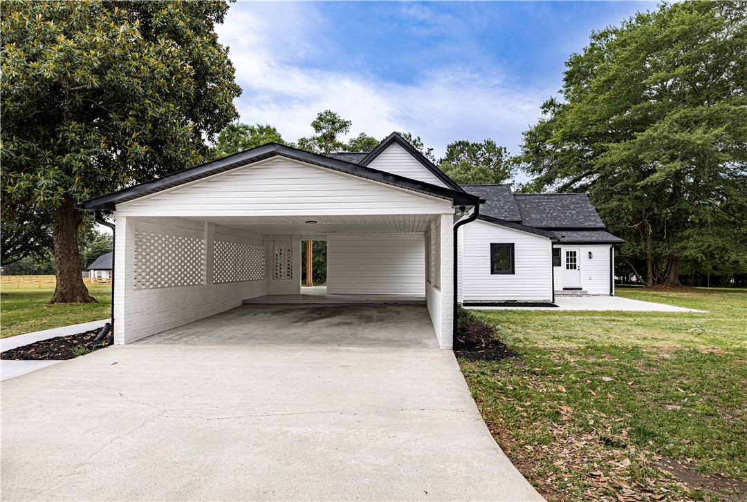 2817 Broadway Lake Road Anderson, SC 29621 - Photo 7 of 41 A newly renovated home offers a spacious carport and expansive grassy areas.