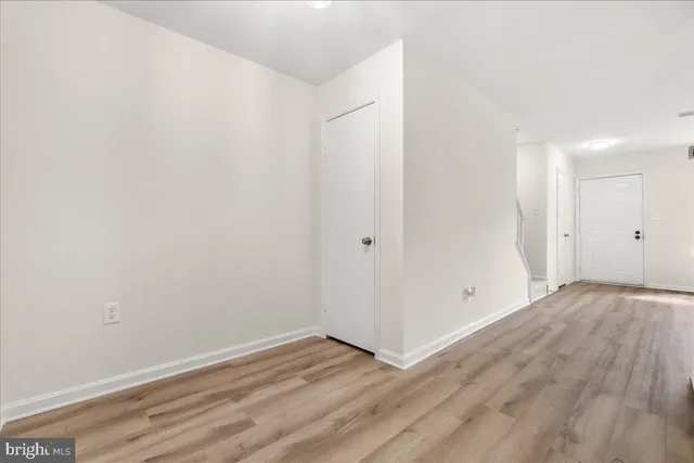 a view of a room with wooden floor