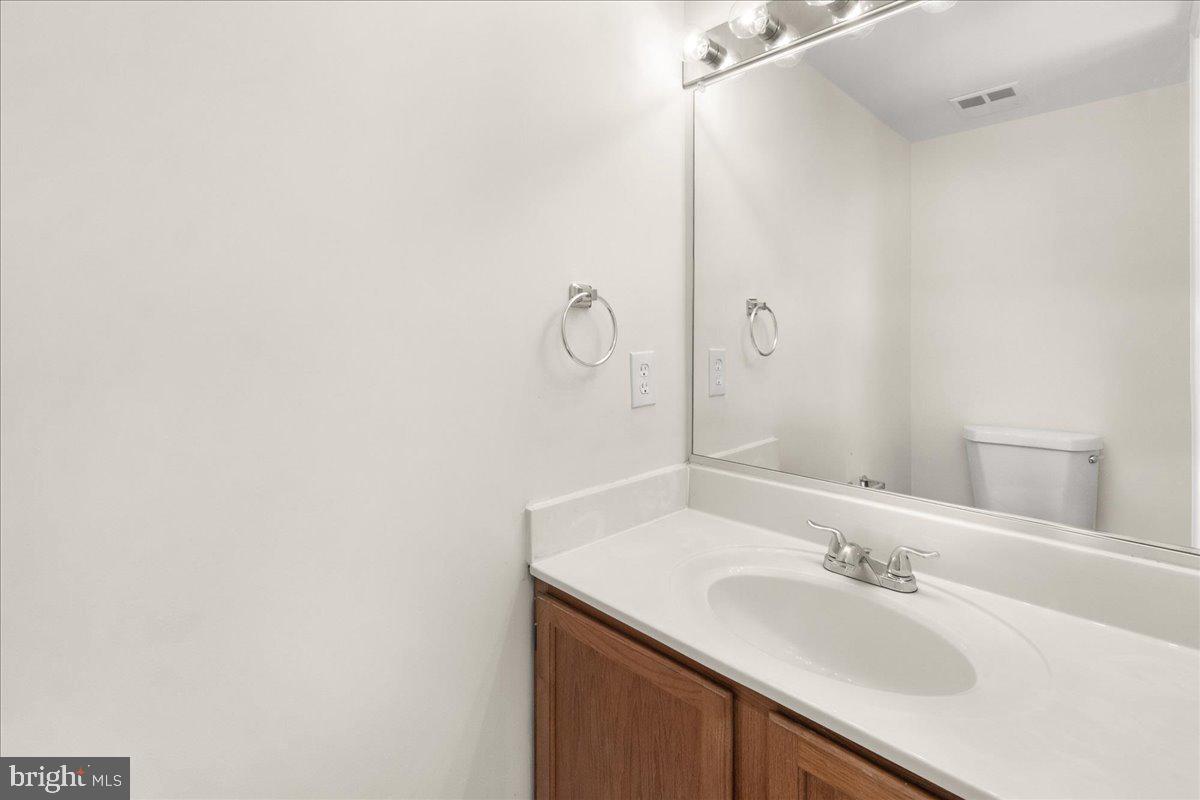 19742 Teakwood Circle, Unit 52 Germantown, MD 20874 - Photo 13 of 29 a bathroom with a sink and a mirror