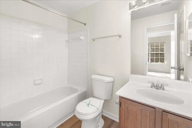 a bathroom with a sink toilet vanity and shower
