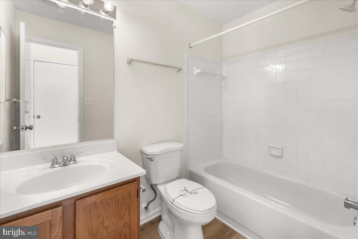 19742 Teakwood Circle, Unit 52 Germantown, MD 20874 - Photo 24 of 29 a bathroom with a sink toilet and shower