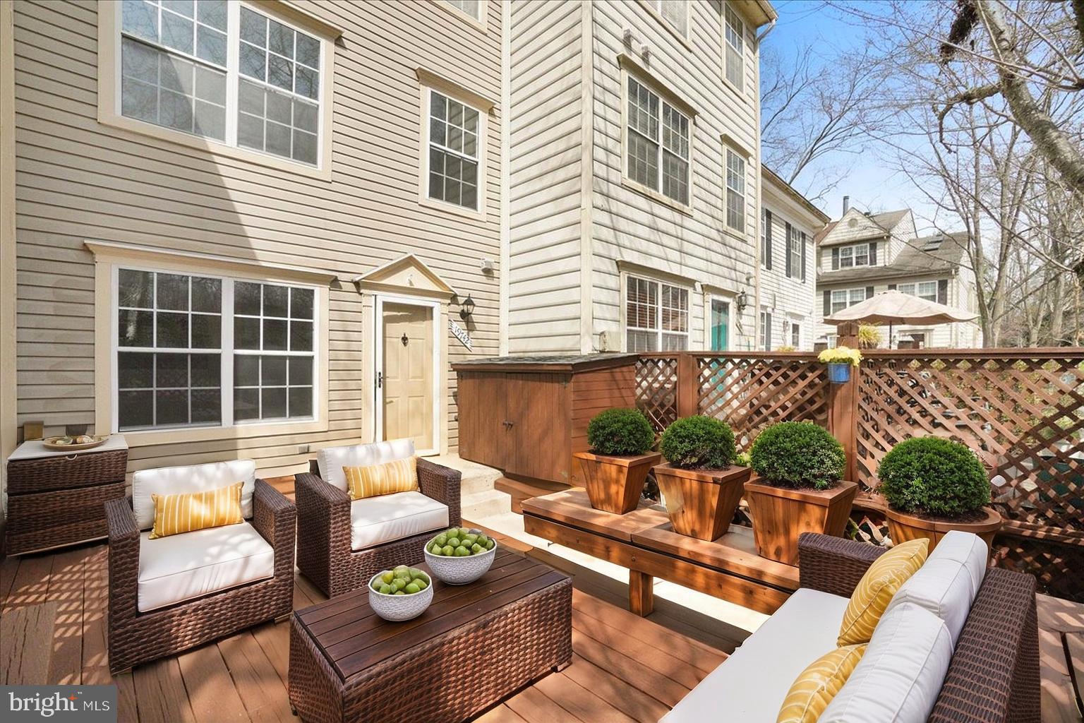 19742 Teakwood Circle, Unit 52 Germantown, MD 20874 - Photo 25 of 29 a view of a patio with couches chairs and a potted plant