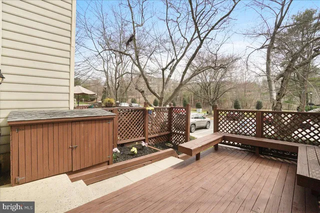 a view of a roof deck with wooden fence and floor