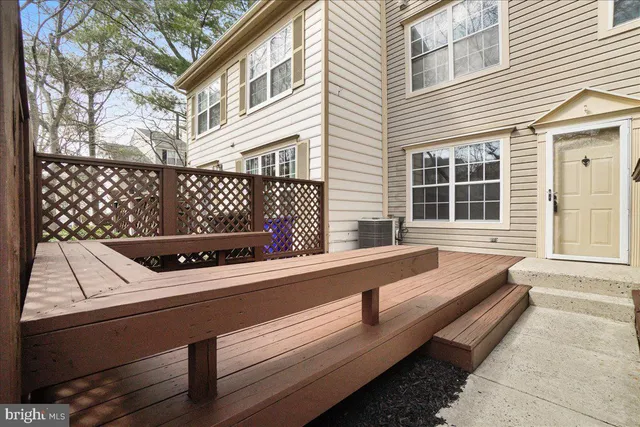 a view of a roof deck with couches and wooden floor