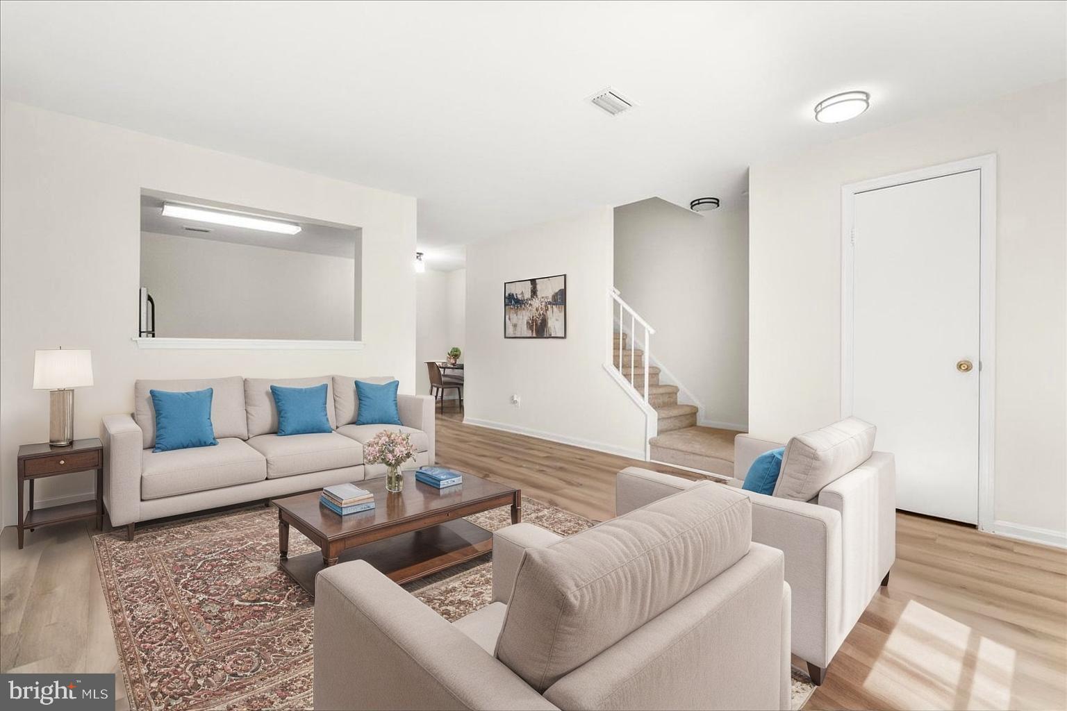 19742 Teakwood Circle, Unit 52 Germantown, MD 20874 - Photo 3 of 29 a living room with furniture and a wooden floor