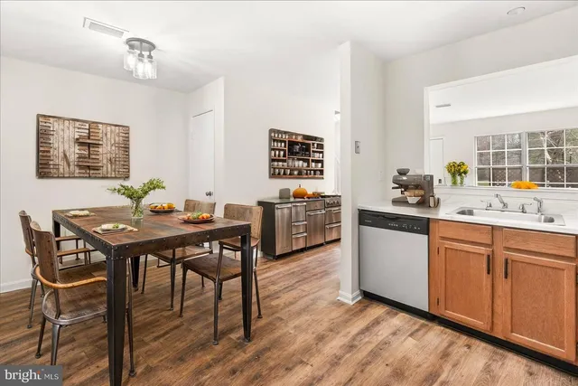 a view of a dining room with furniture window and wooden floor