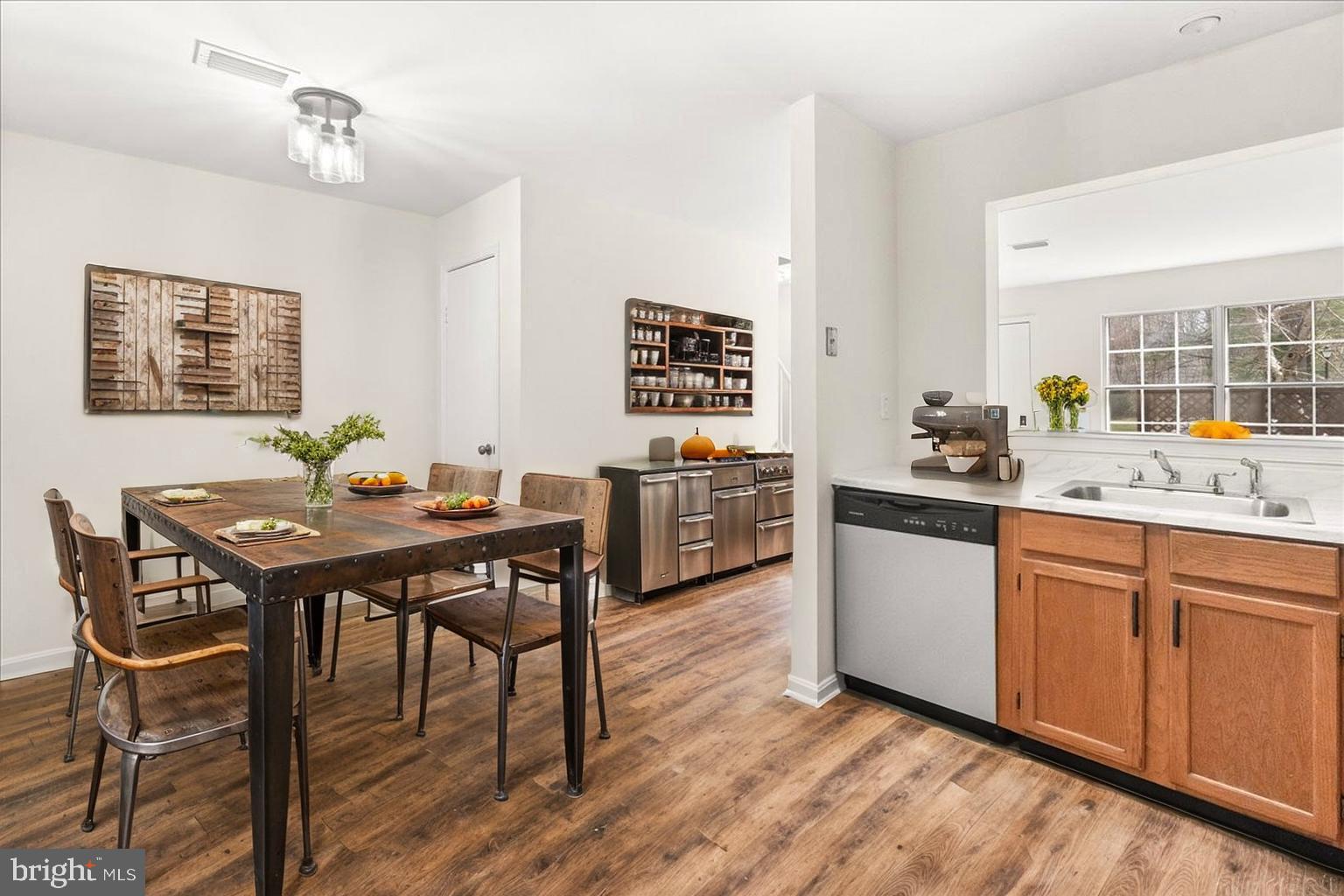 19742 Teakwood Circle, Unit 52 Germantown, MD 20874 - Photo 9 of 29 a view of a dining room with furniture window and wooden floor