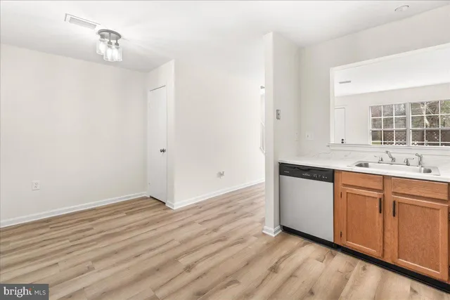 a view of kitchen with granite countertop cabinets and wooden floor