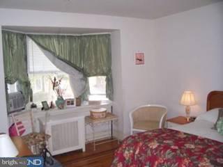 902 Marlyn Road Philadelphia, PA 19151 - Photo 6 of 6 a bedroom with a bed and wooden floor