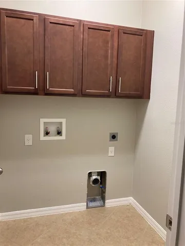 a view of a refrigerator and cabinets