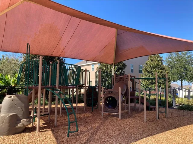 a patio with a table and chairs under an umbrella