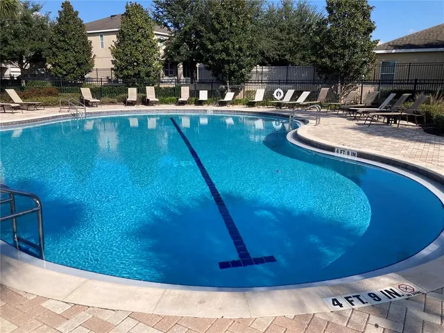 a view of a swimming pool with outdoor seating