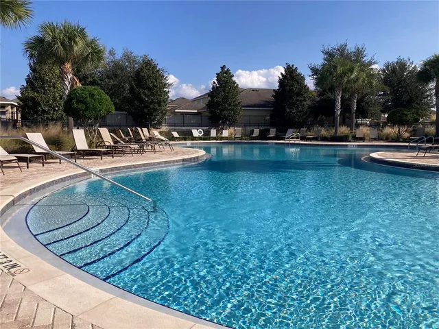 a view of a swimming pool with outdoor seating and yard