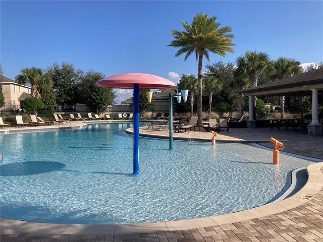 swimming pool view with a seating space