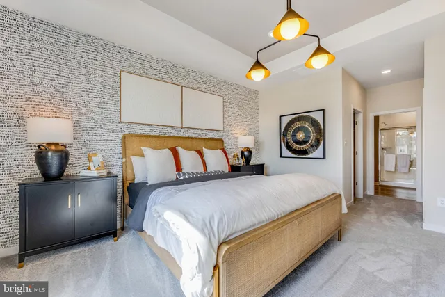 a bedroom with a bed and painting on the wall