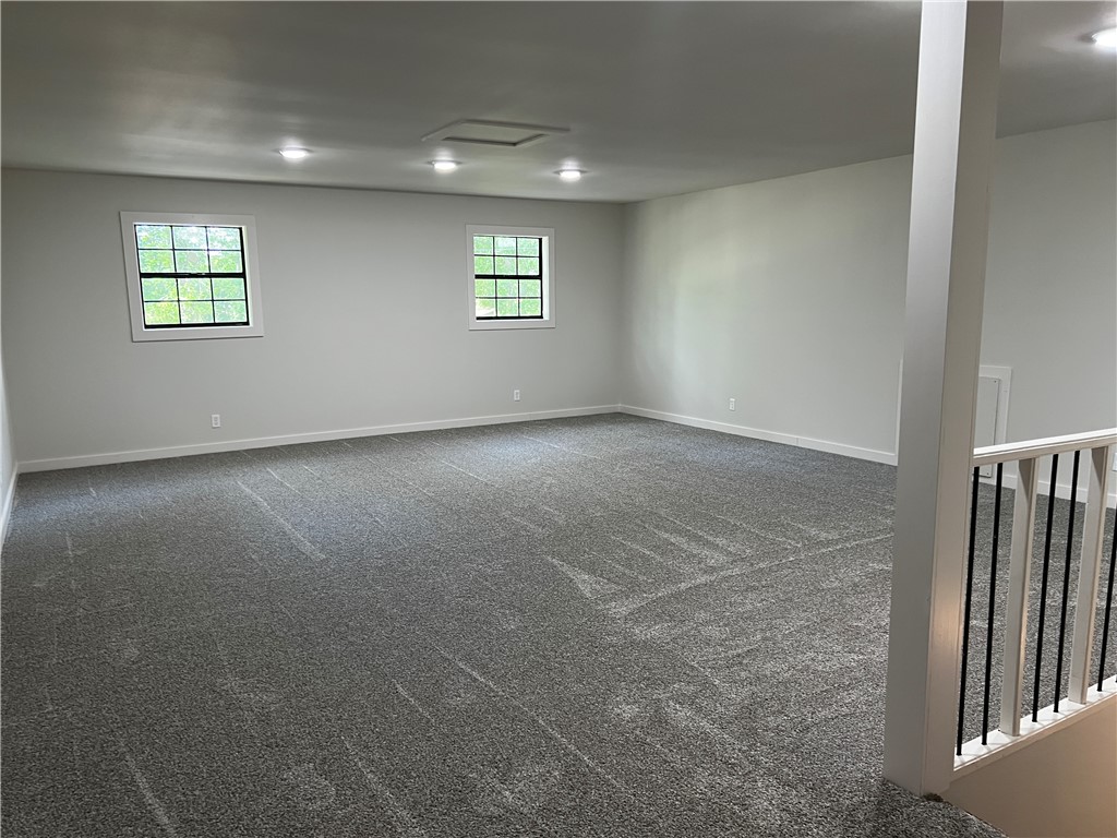 213 Carter Road Pottsville, AR 72858 - Photo 29 of 41 Spacious bonus room featuring new gray carpet, recessed lighting, white trim, and two double-hung windows