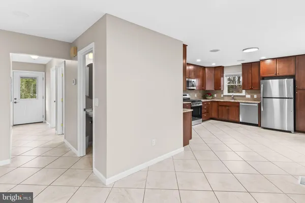 a kitchen with stainless steel appliances a refrigerator sink and cabinets
