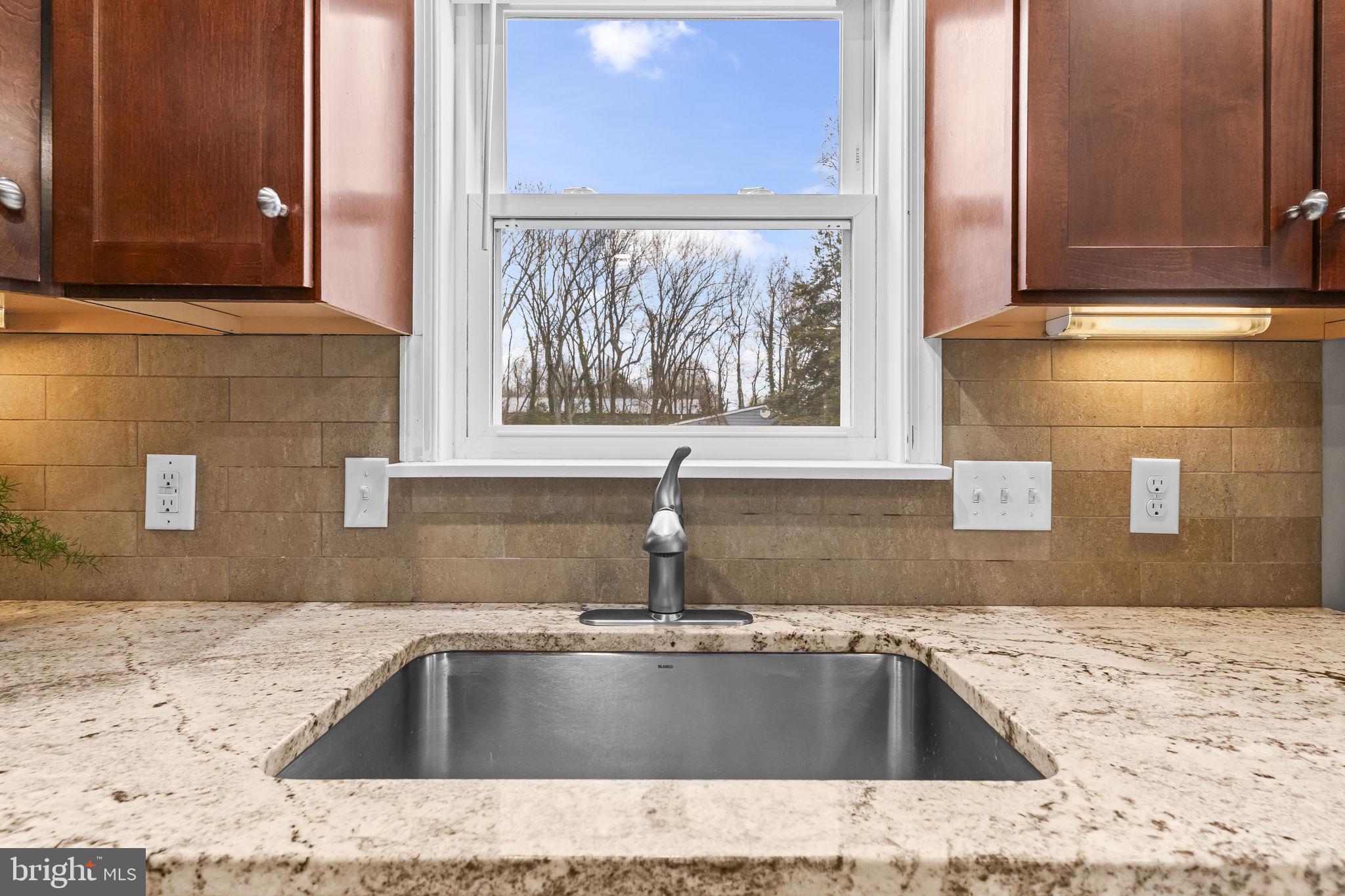 25001 Half Pone Point Road Hollywood, MD 20636 - Photo 15 of 40 a view of a kitchen sink a faucet and appliance in the kitchen