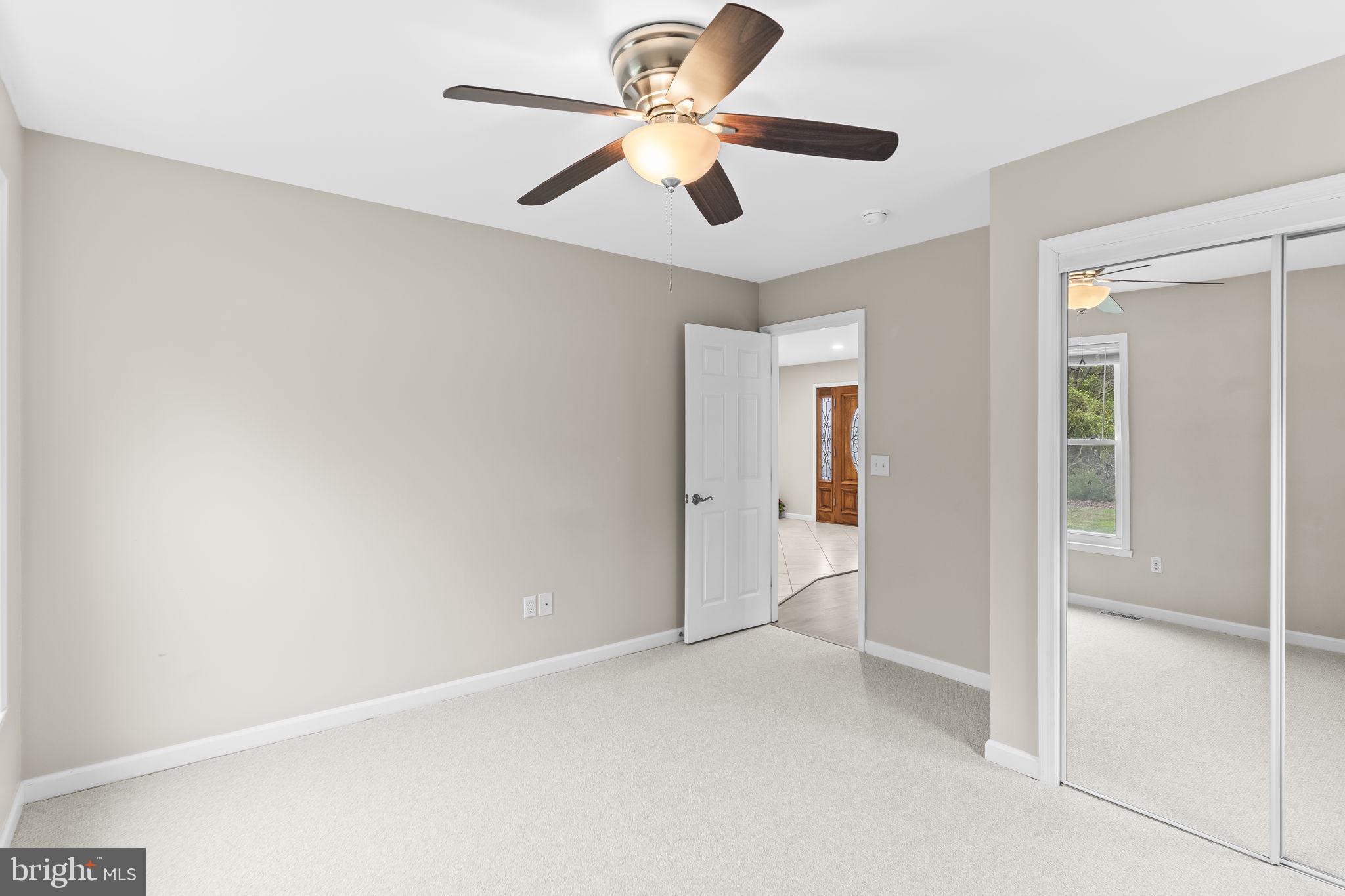 25001 Half Pone Point Road Hollywood, MD 20636 - Photo 17 of 40 an empty room with fan and a ceiling fan