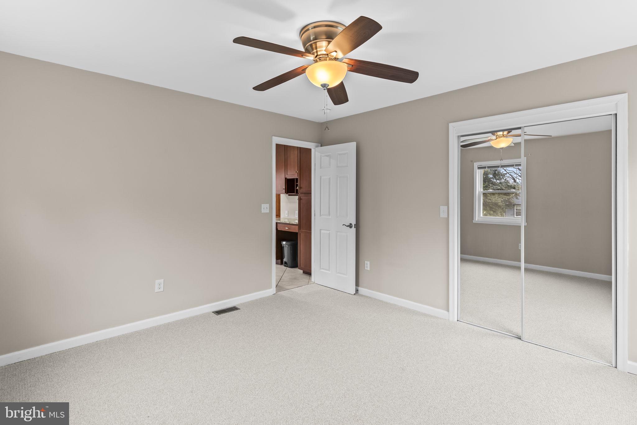 25001 Half Pone Point Road Hollywood, MD 20636 - Photo 18 of 40 an empty room with closet and a ceiling fan