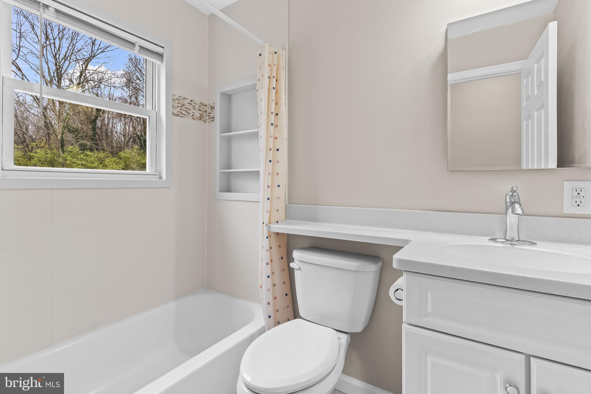 25001 Half Pone Point Road Hollywood, MD 20636 - Photo 19 of 40 a bathroom with a sink toilet and vanity