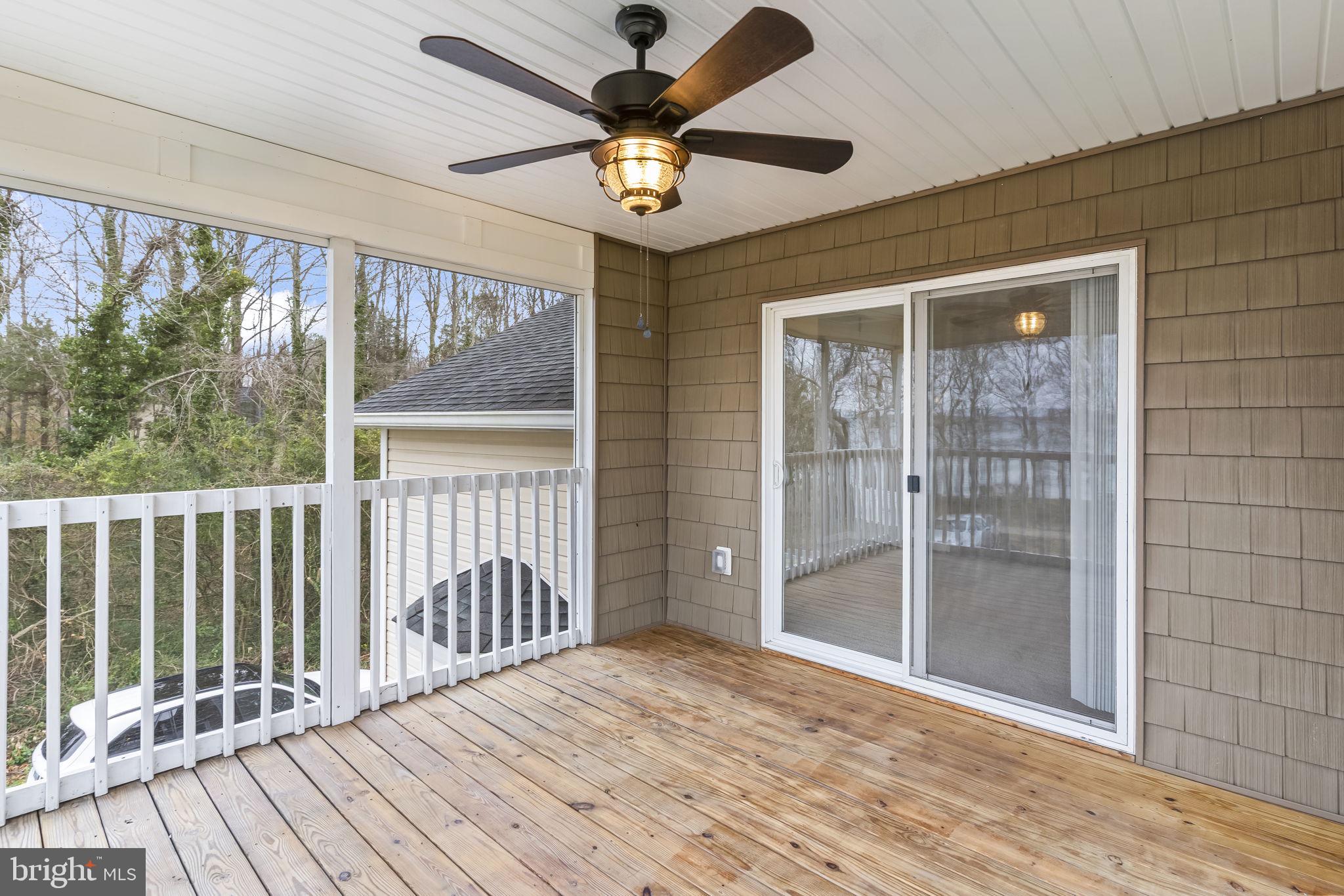 25001 Half Pone Point Road Hollywood, MD 20636 - Photo 30 of 40 a view of a livingroom with wooden floor and a ceiling fan