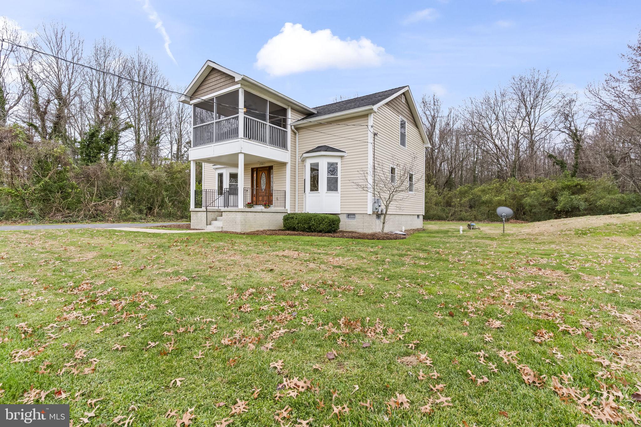 25001 Half Pone Point Road Hollywood, MD 20636 - Photo 4 of 40 a front view of a house with a yard