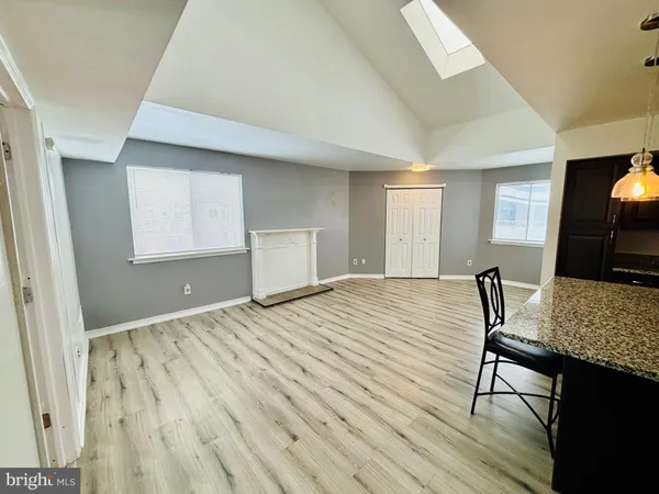a view of a kitchen with cabinets and wooden floor
