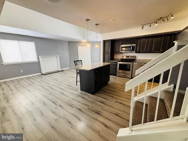 a living room with furniture and kitchen view