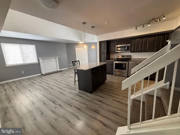 a view of a room with wooden floor and window