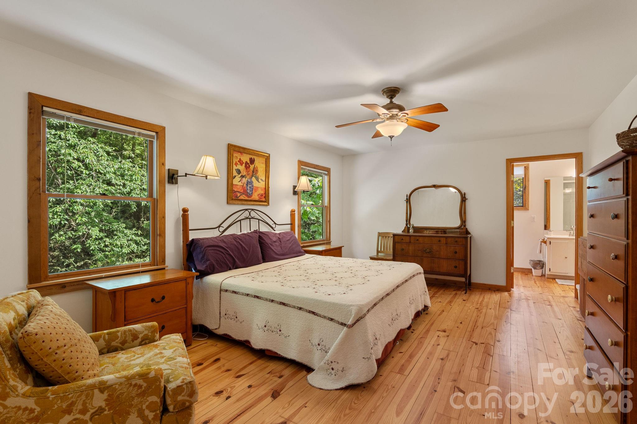 150 Avondale Ridge Road Asheville, NC 28803 - Photo 34 of 45 a bedroom with a large bed and a chandelier