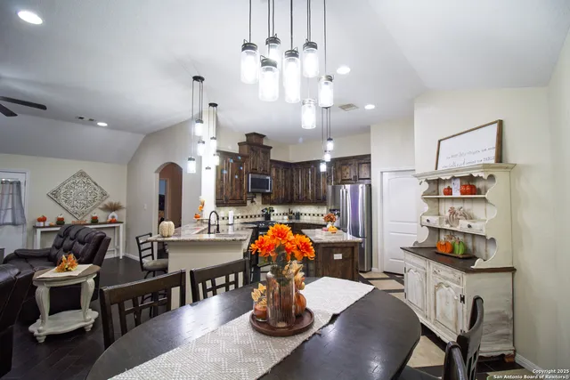 a dining room filled with furniture and chandelier