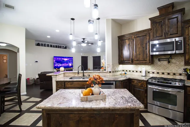 a kitchen with a stove a sink and a microwave