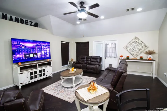 a living room with furniture and a flat screen tv