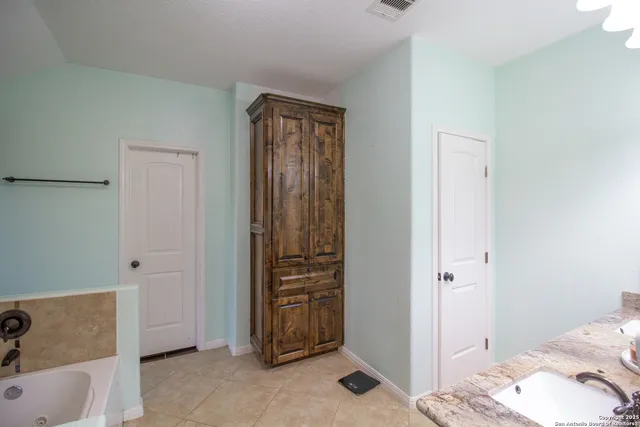 a bathroom with a tub and a sink