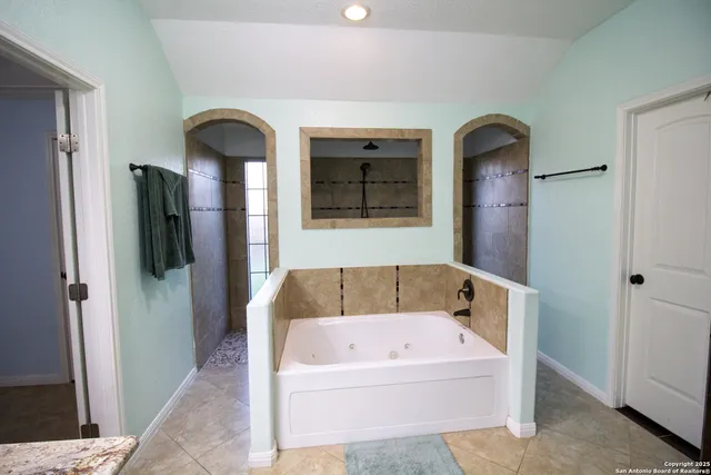 a bathroom with a bathtub and a shower